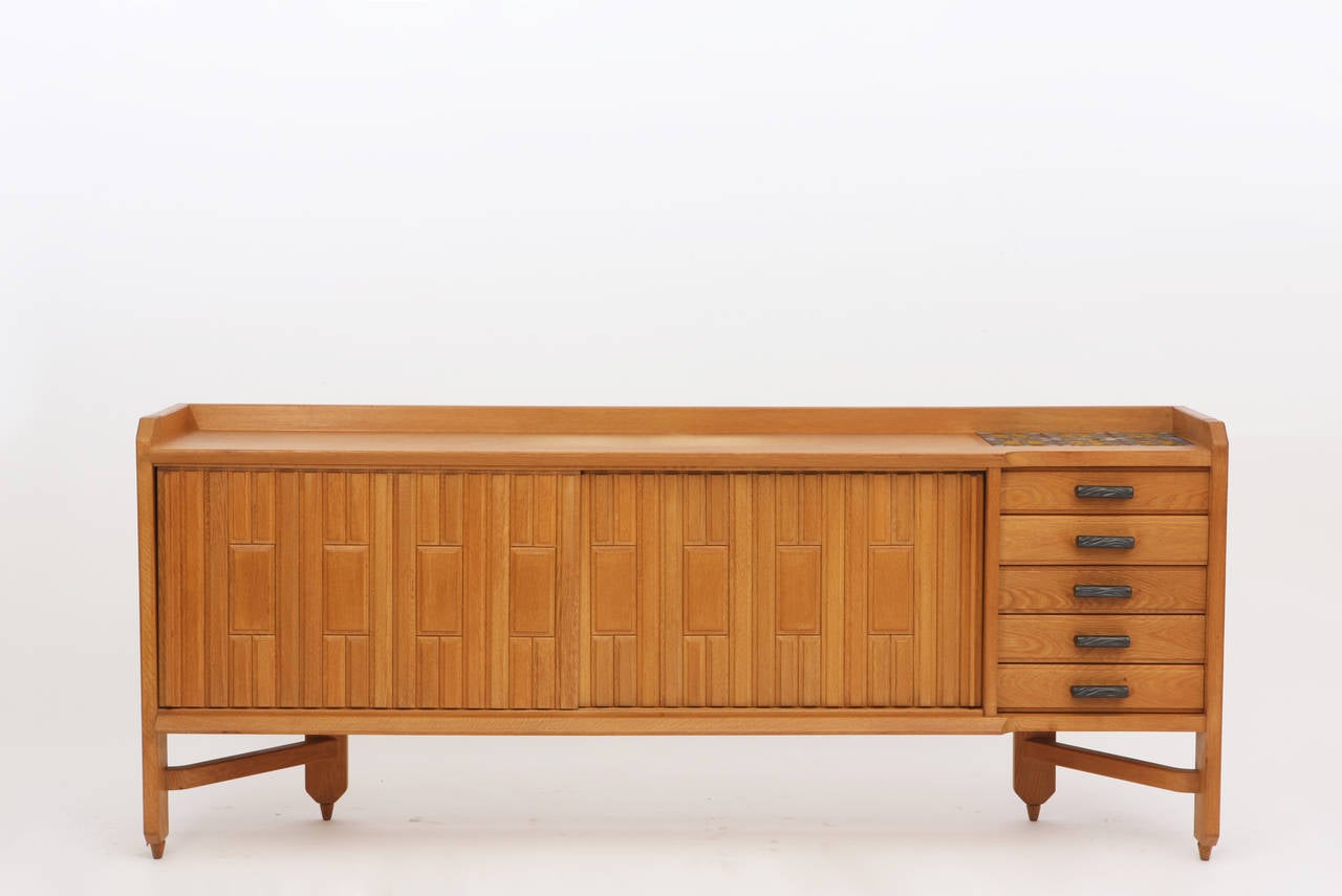 Guillerme et Chambron sideboard, circa 1950.
Wood and ceramic tiles.