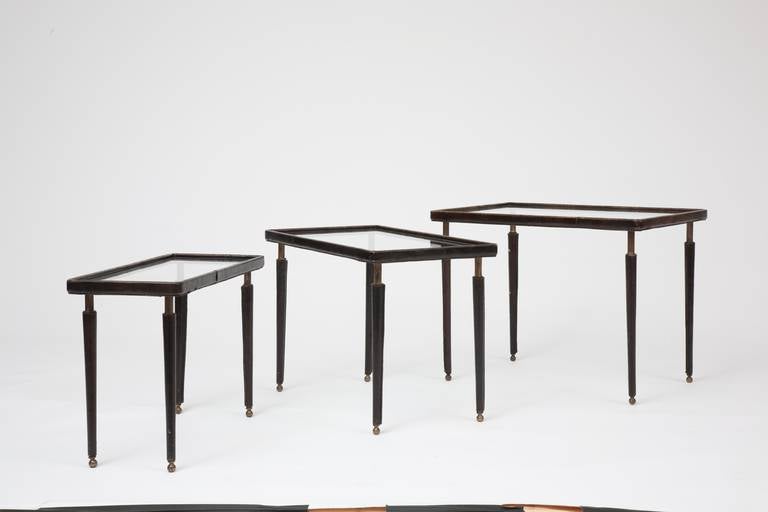 Jacques Adnet - Nesting table, c. 1950
Metal, leather

Large: 17.25H x 22.5W x 16D inches / 43.8H x 57.2W x 40.6D cm
Medium: 15.75H x 22.25W x 12.5D inches / 40H x 56.5W x 31.8D cm
Small: 14.25H x 22.25W x 8.8D inches / 36.2H x 56.5W x 22.4D cm
