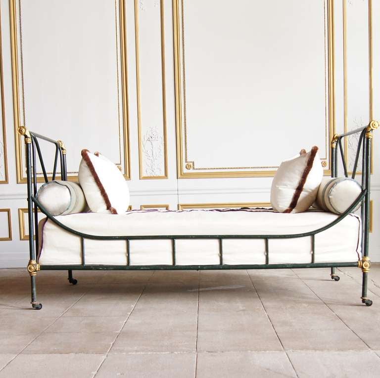 This beautiful green and gilt painted iron daybed was made by Maison Jansen in the Empire style. It retains all its original bronze escutcheons that hide the screws used to assemble. The paint is original and has amazing patina. Custom mattress and
