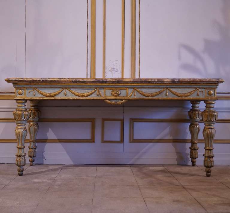 This large scale Italian painted console retains its original paint with some minor restoration. The original top is a marquetry of Sienna Marble typical of consoles from the region of Torino. It can be dated to the end of the 18th century.