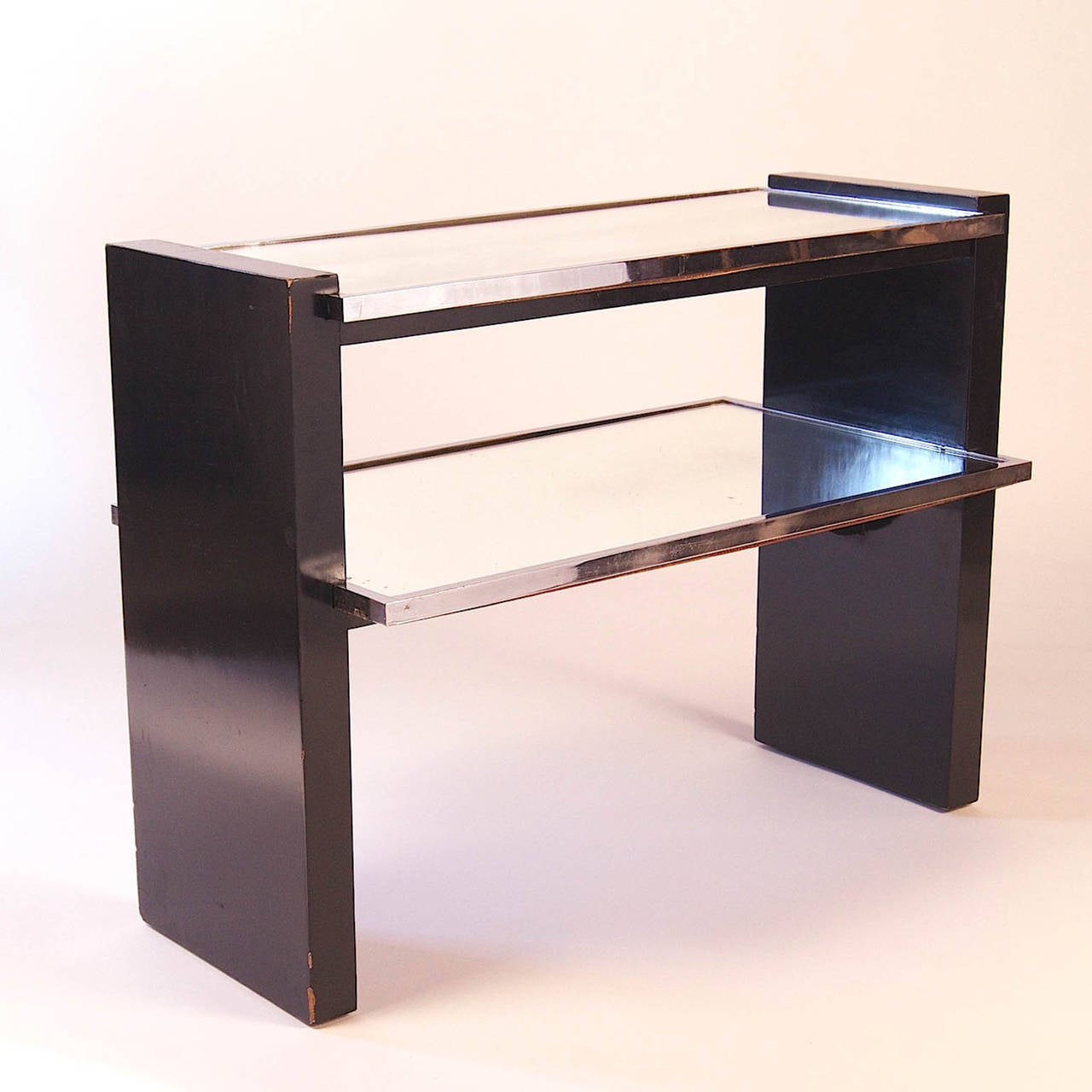 Black lacquer, steel and mirrored side table by Jacques Adnet, France, 1950s.