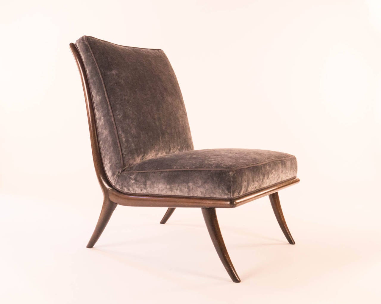 Sabre leg slipper chair by T.H. Robsjohn-Gibbings, mid-20th century.