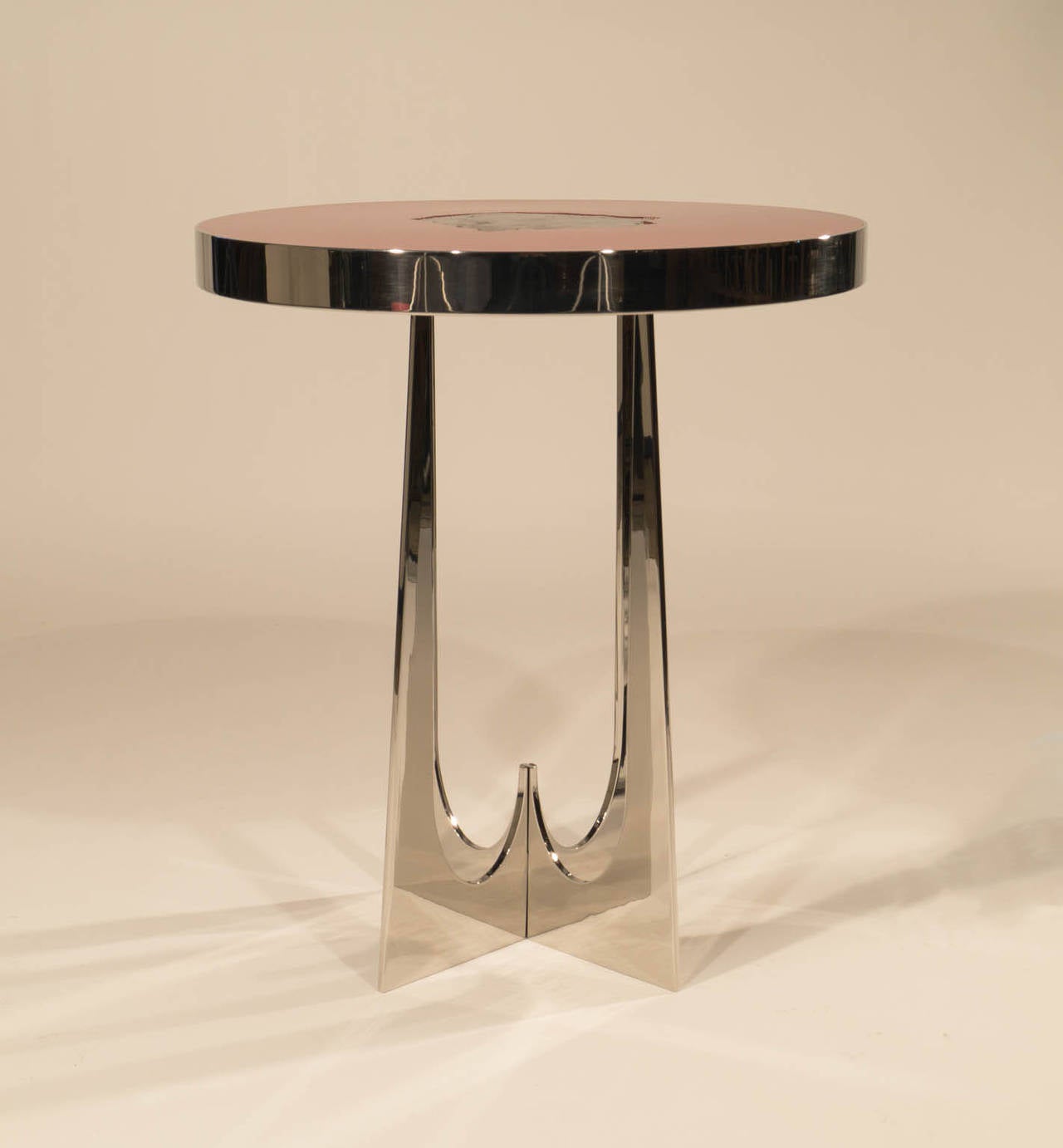 Beautiful stainless steel and resin with a Meteorite inclusion side table designed by Adam Thomas Hebb. His work with resin, ammonite and/or stone make each of his pieces a little unique jewel. They are handmade in his studio in Los Angeles.