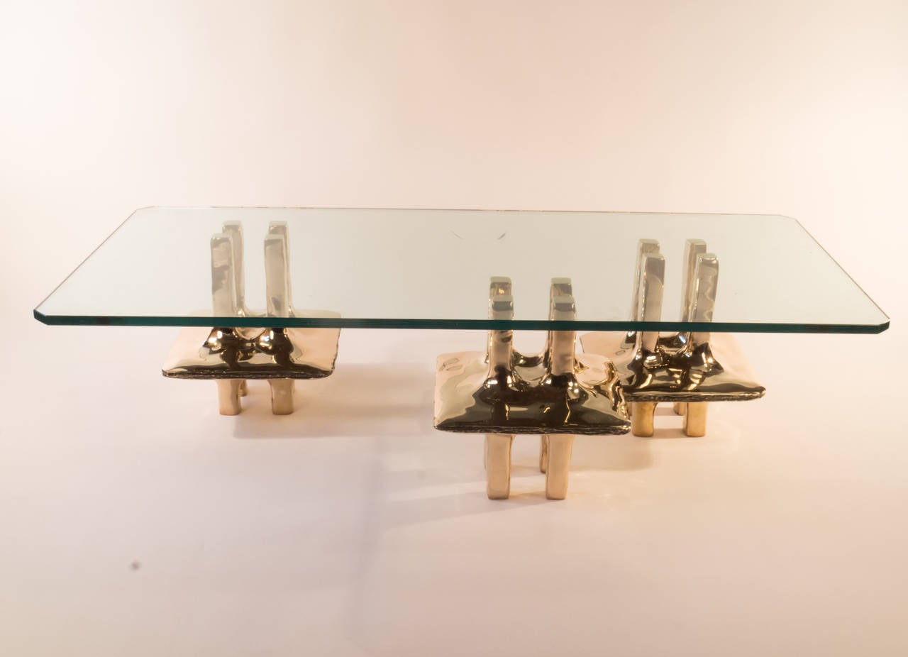 Adam Hebb has created this design for a coffee table or a side table out of individual cast bronze modules. We are showing 2 different configurations. A larger coffee table can be created by adding an additional module(s). Each additional piece is