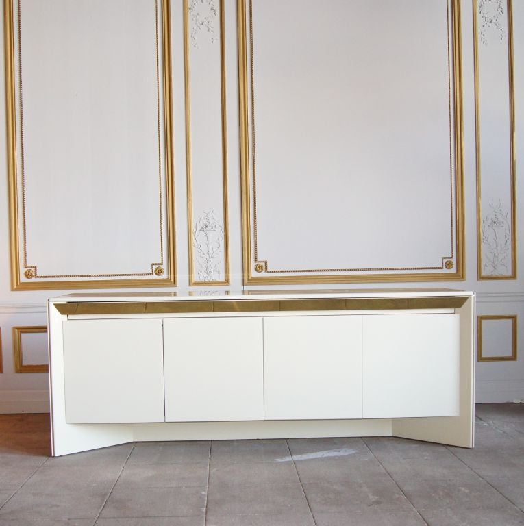 Ivory lacquer and brass accent four door buffet with silver drawer by Rougier, Canada. Silver cloth stamped Rougier. Doors are touch latch.