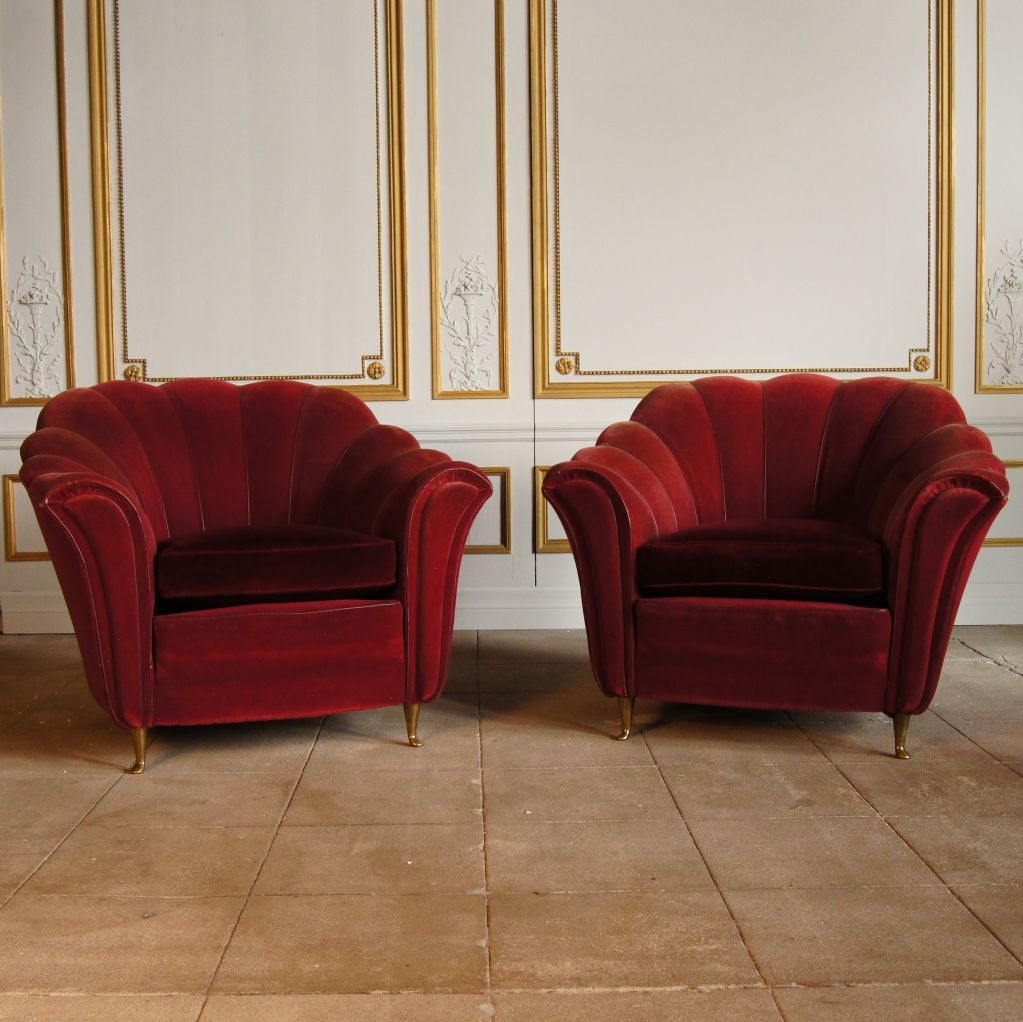 Pair of Italian club chairs with bronze feet.