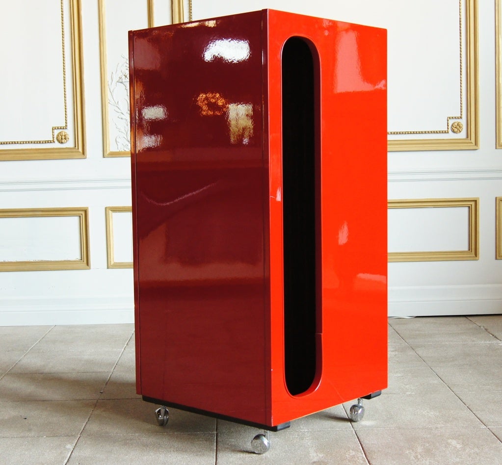 Raymond Loewy Cabinet with four drawers (bottom drawer is larger). Has a flip-open bottom for shoes, and hidden top opens for a mirror and key tray.The back of the valet is designed to hang clothes. The valet is on casters with molded polycarbonate