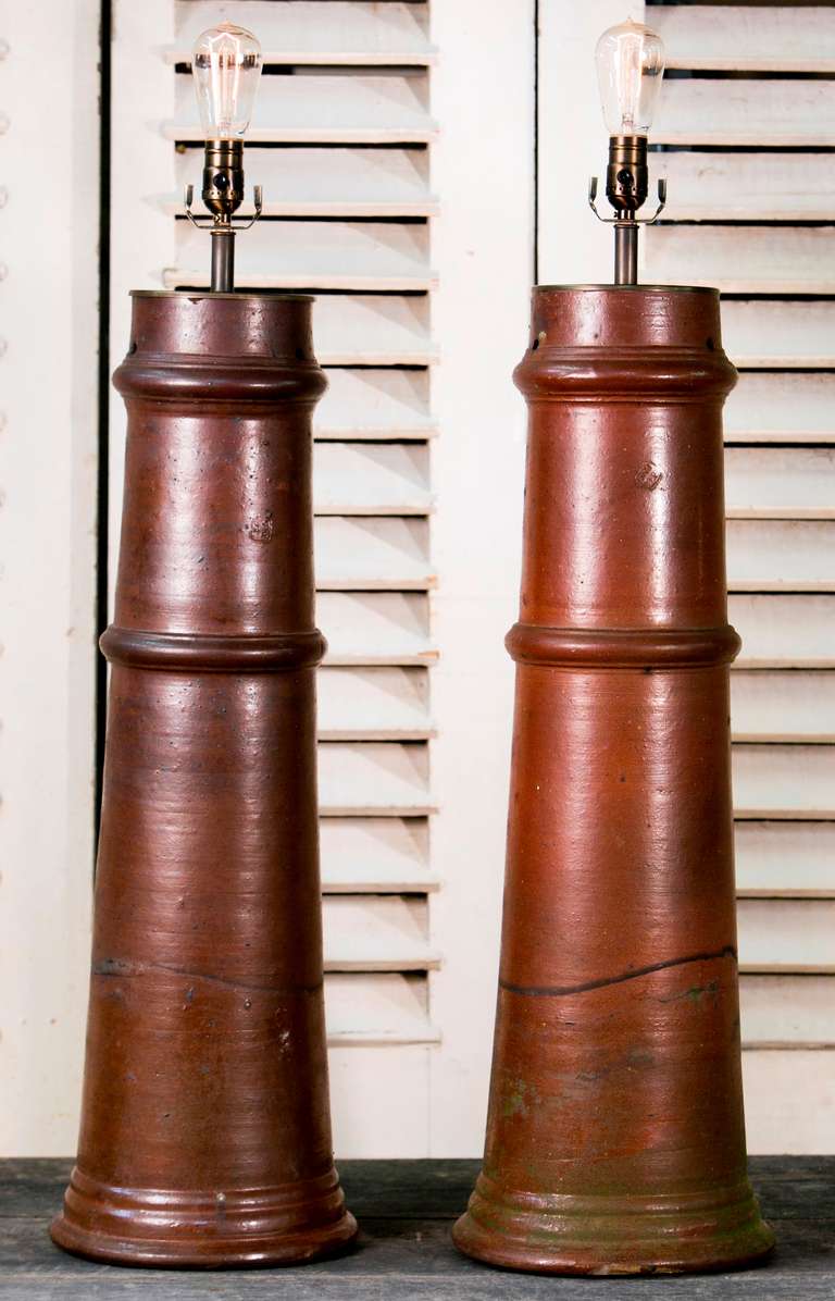 Large industrial style floor lamps made from pottery

Belgium circa 1940s

Re-wired for USA with edison sockets

Price is for the pair