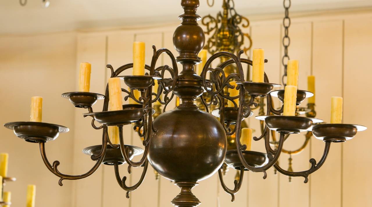 Beautifully cast 16-arm bronze chandelier in the Flemish Baroque style. Circa 1920s. Re-wired with candelabra sockets using UL-approved parts. Wonderful patina.