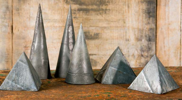 Set of six vintage zinc geometric shapes. From a Belgian school house. Likely date from the 1950s. 
 
Pyramides measure 6 by 6 inches. Cones measure 12 inches tall by 3 inches wide.