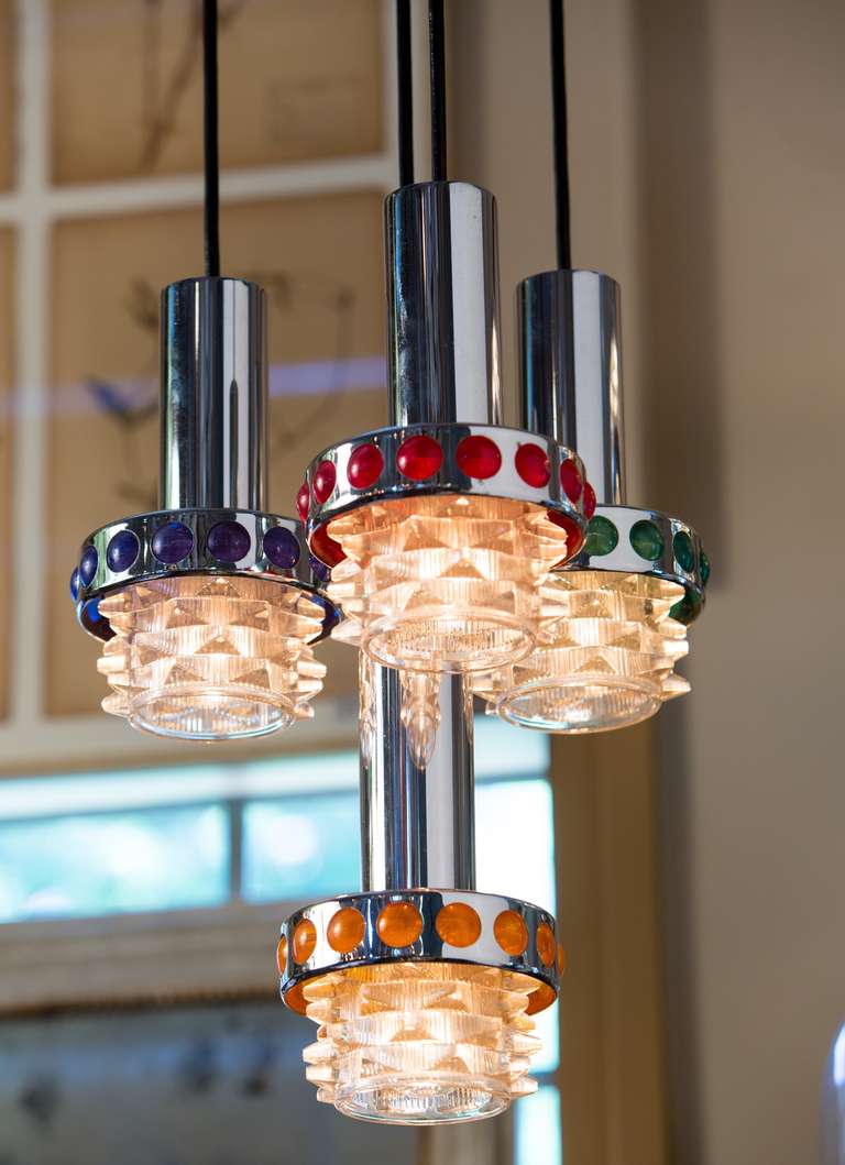 Very unique and interesting mid-century pendant light by RAAK. 4 Lights with different colored glass circles connected to one canopy. From the Netherlands circa 1960s. Chrome and glass.