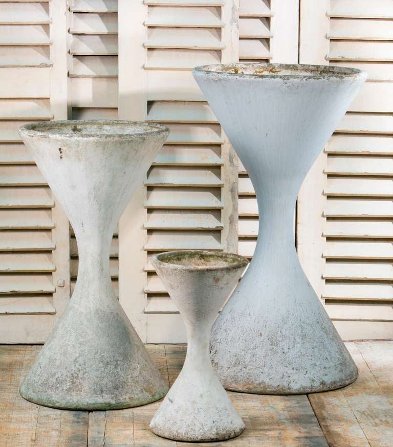 Set of three vintage Willy Guhl Diablo Planters fromFrance circa 1950's. 
Mid-century modern design;beautiful in a garden  or as interior decorative objects. The smallest has a crack at the neck that has been repaired with a steel rod and concrete