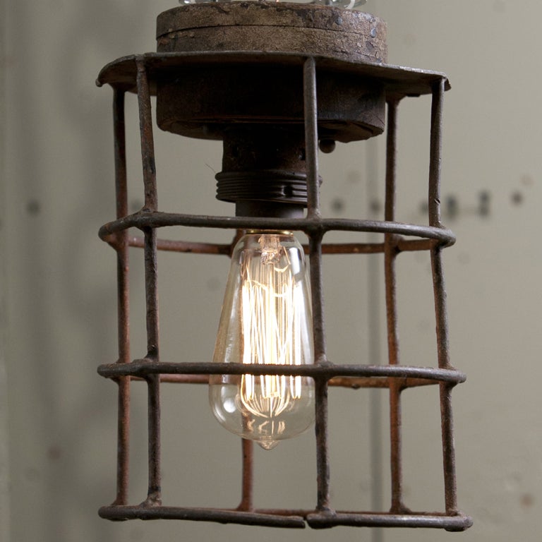 Iron and wood Industrial lights from Belgium, circa 1920. Newly wired in the USA with all UL listed parts and a single porcelain Edison socket. Shown on a chain for photography purposes but is a flush mount light. Sizes vary slightly, as they are