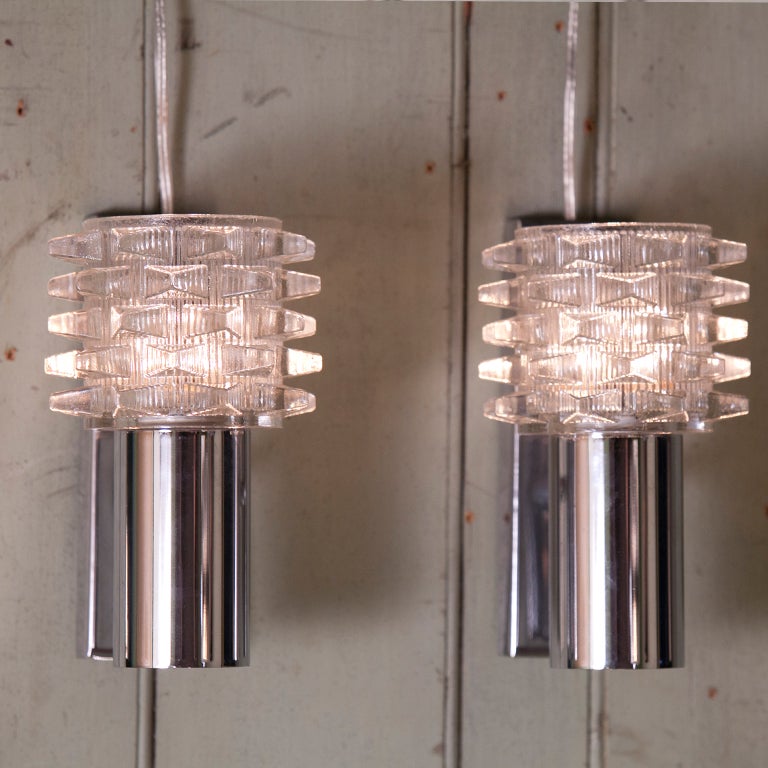 Unusual chrome and glass sconces from Italy. These sconces may be hardwired and can be hung in either direction. Newly wired in the US. Price is for the pair.