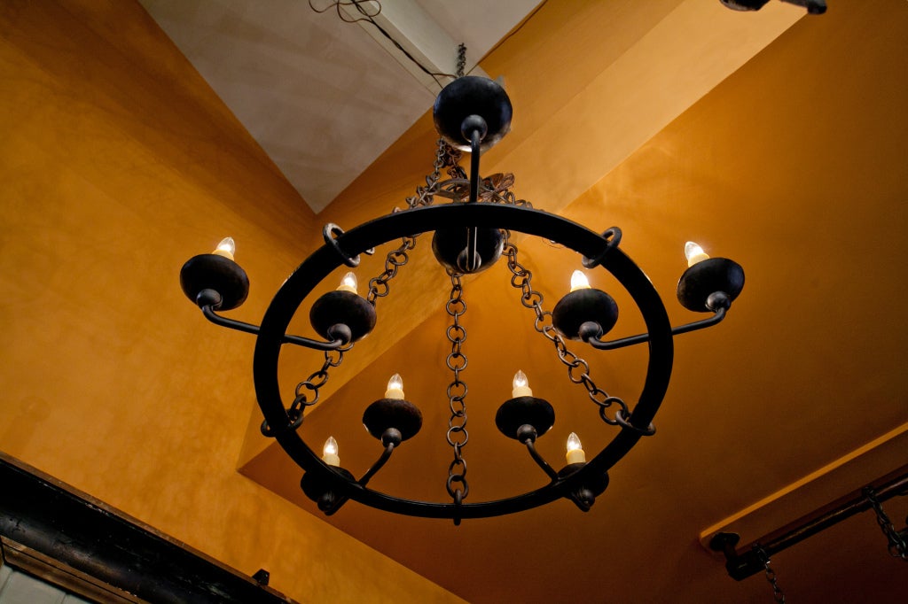 Our exclusive design, this hand-forged, blacksmith-made iron light features ten Edison based sockets.  Two sockets on each arm- one inside the ring and one outside. Hand-made round iron links of chain connect the ring to the connector at the