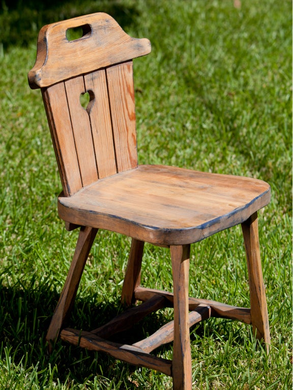 The chairs and sturdy, comfortable and full of charm.
Constructed of waxed, old pine wood. Thick plank seat and pierced back with a heart shape cut-out and handle at the top of the backrest. Would look great in a mountain or country home. Price is