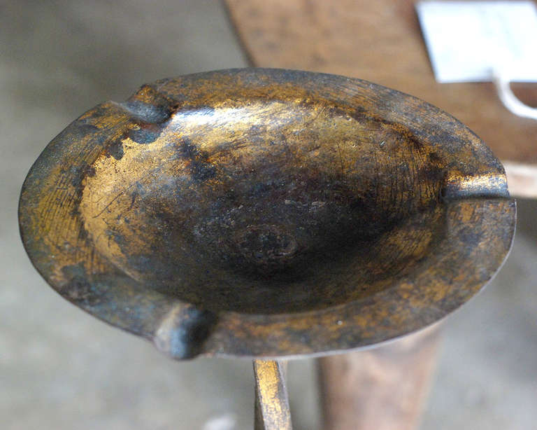 Vintage gilt iron ashtray on stand.
