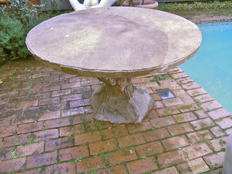 Handsome French 20th. century faux bois garden table in cement.Nice large size. Traces of some old red paint.