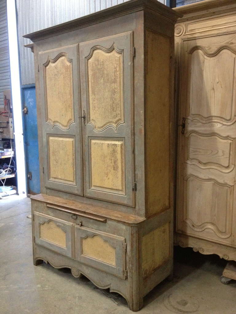 Handsome and unusual French Louis XVI deux corp. Hand scraped to original paint. Two upper doors over unusual buffet base with sliding shelf. All in one piece.