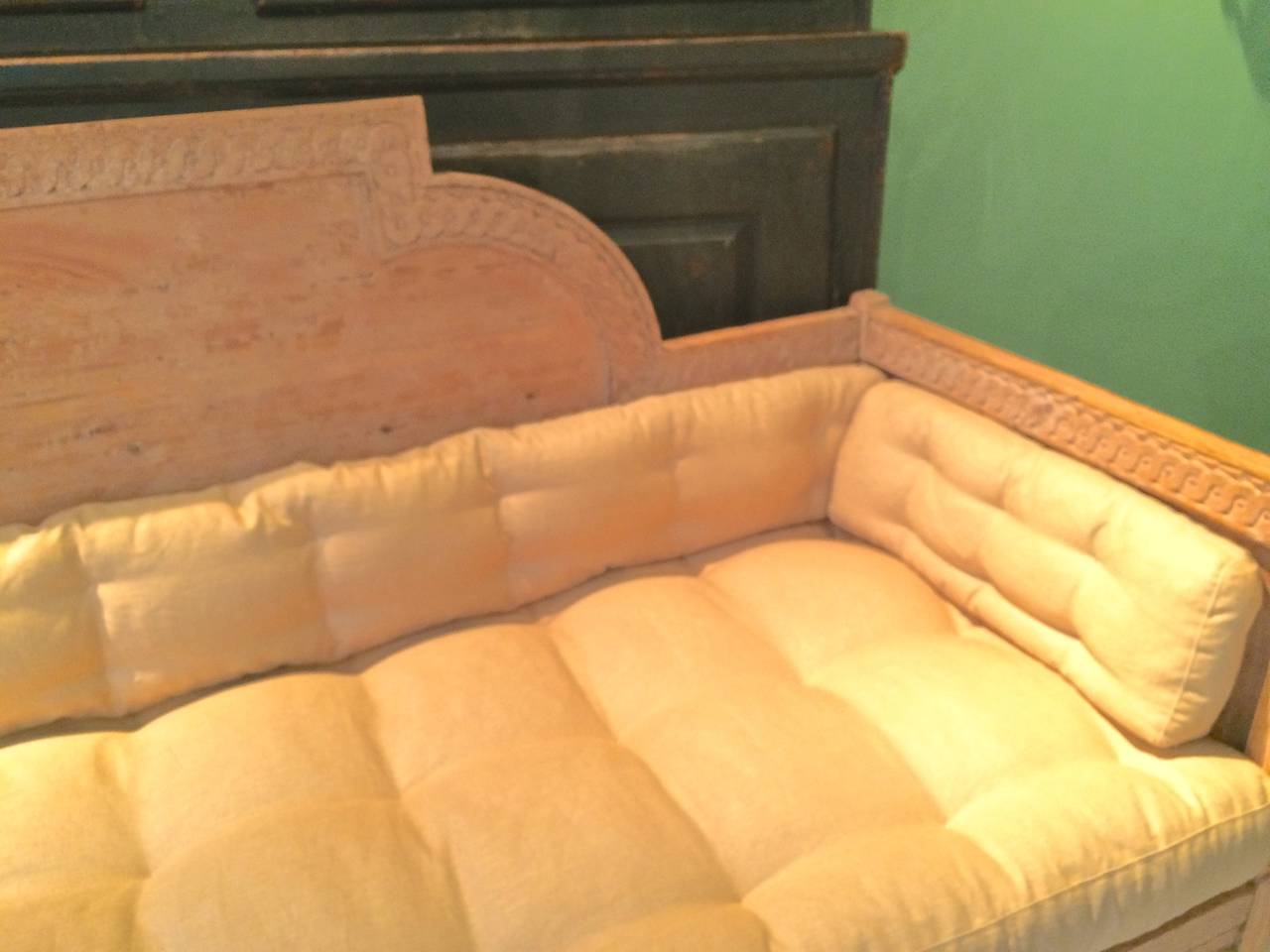 Handsome Swedish Gustavian settee in salmon paint. Beautifully carved details. Newly upholstered in Irish linen. The four corner finials have been missing for some time. Traces of flater aux bois.