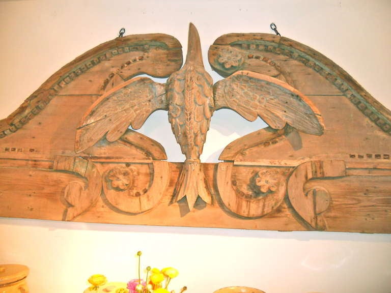 Interesting Georgian English carved pine exterior over door panel from a shop. Broken pedement surrounding an eagle or albatros with applied dental moldings, scrolls and flowers. Very naieve.Some traces of old paint.