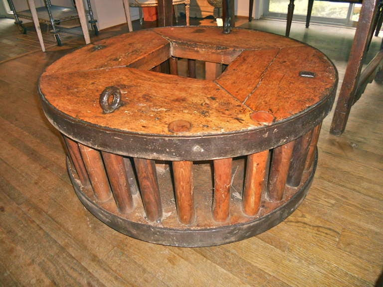 Handsome and unusual wooden and wrought iron gear from a mill. Beautiful patina. Made of walnut and other mixed woods.
