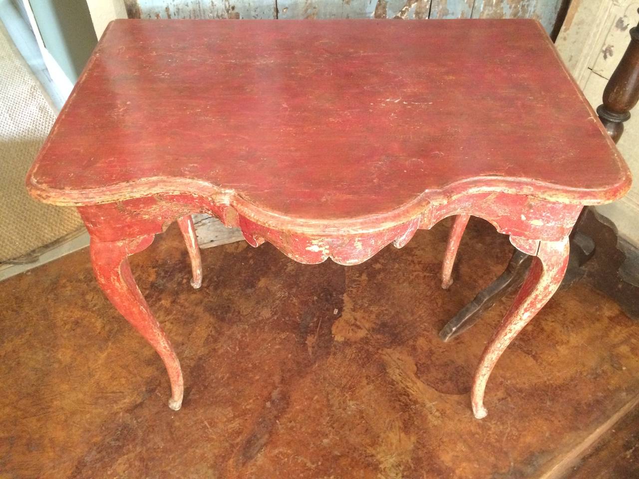 Unusual and graceful Swedish Rococo serpentined painted console. Traces of original gilt decoration.. Graceful cabriole legs.