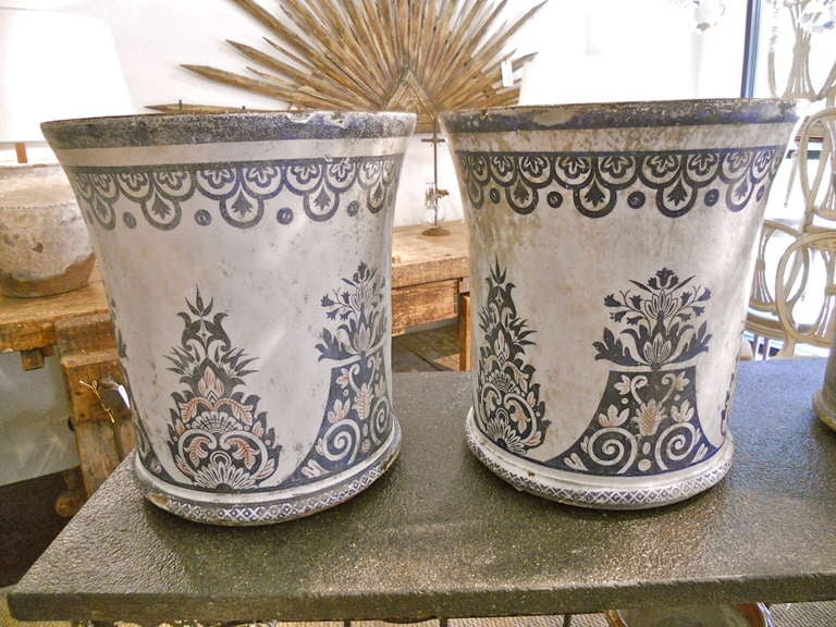 Handsome and rare pair of large enameled cast iron jardinieres, referred to as 