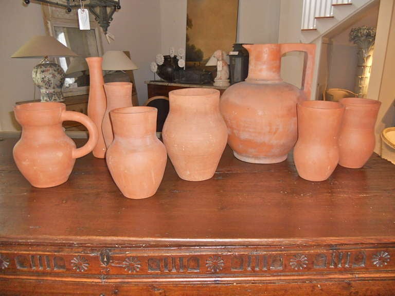 Handsome set of 8 vases and pitchers from Vallurice ,France. Unglazed terracotta. Ranging in size 18 1/2