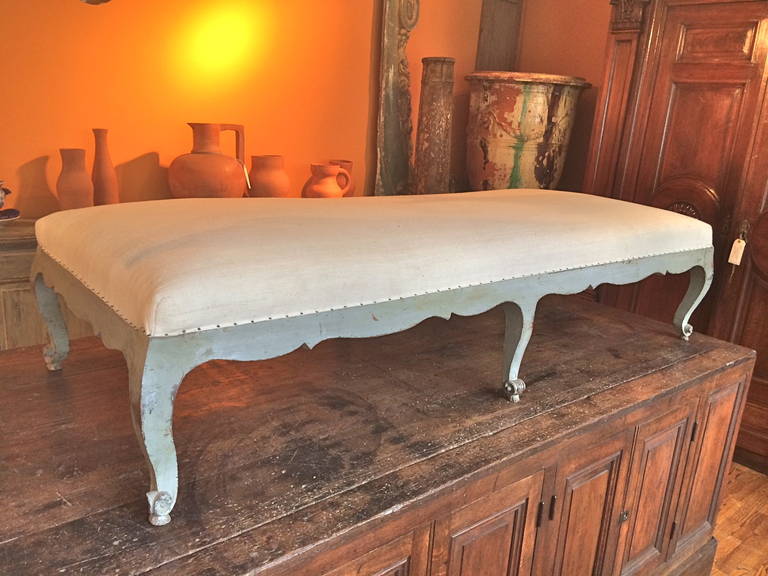 Handsome and large painted French bench with beautiful bolded shaped cabrieol legs with deeply sculpted escargot leg endings.