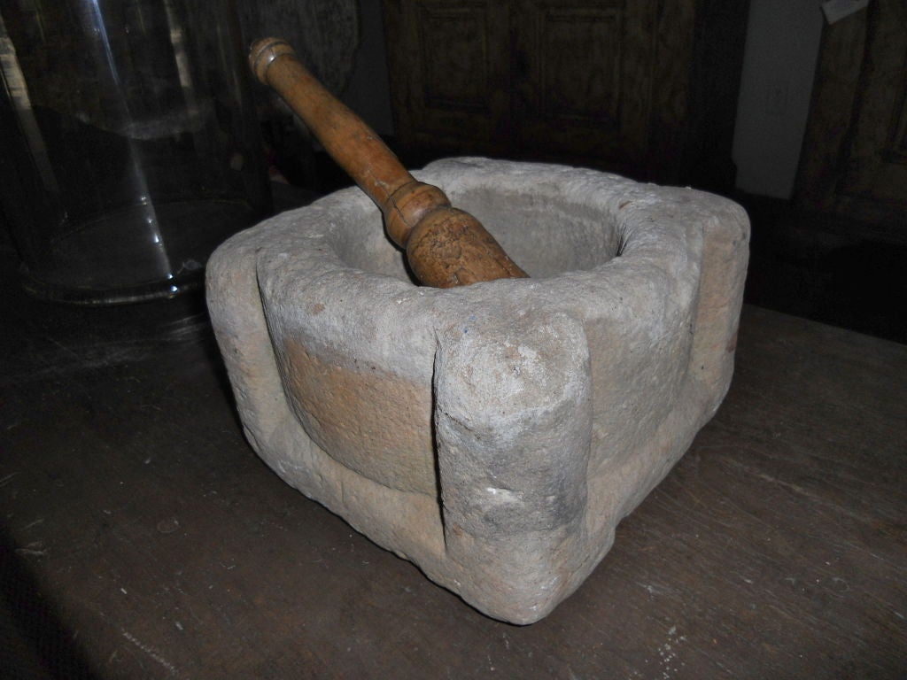Handsome and unusual stone mortar from Spain. Beautifully and simply carver. Pestle is 19th.c. walnut probably French.