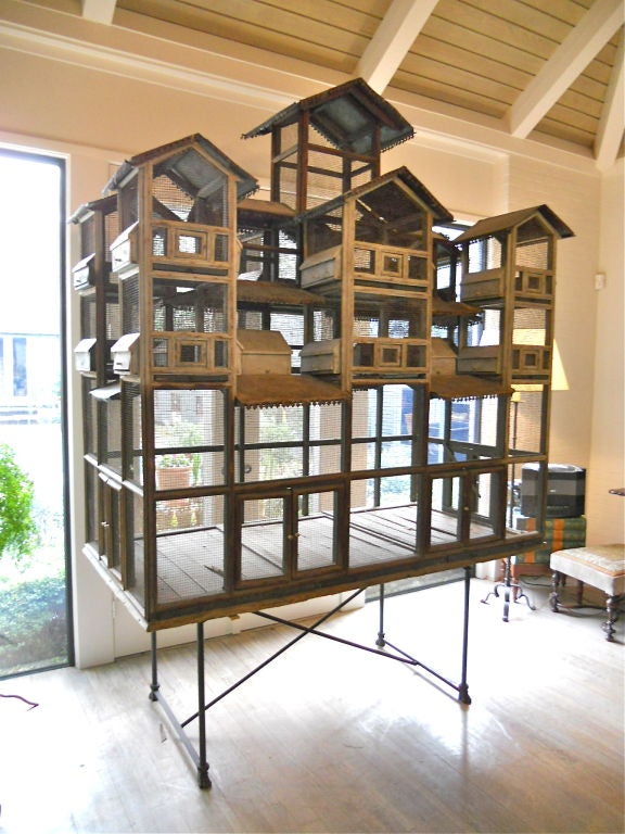 Hugh Italian whimsical bird house.Twelve smaller cages,each separated by wooden tray for cleaning or combining. Bottom cage is the full width and depth ,extending up into the center and topmost cage. Bottom has 3 removable sliding tray for cleaning.