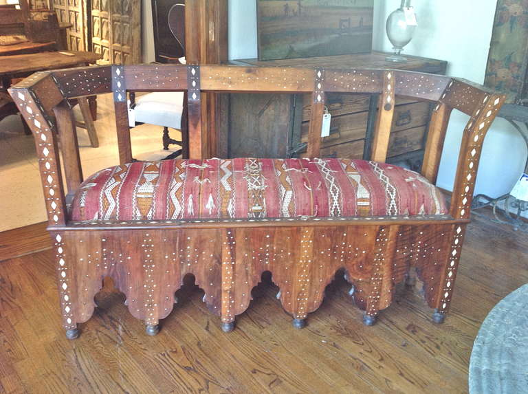 Handsome and  unusual sette from Damascus ,inlaiyed with bone and metal studs. Interesting cut shirt on raised turned feet. Beautifully constructed of beautifully grained cedar. Upholstered in an antique textile.