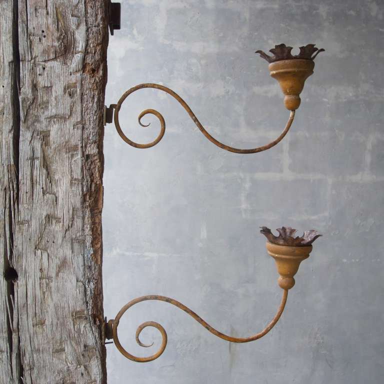 This is a simple pair 18th century Italian iron and wood applique scones. They portray their original yellow color but some patina due to age. They are small and have a place to display candles. They can also be electrified if desired. 