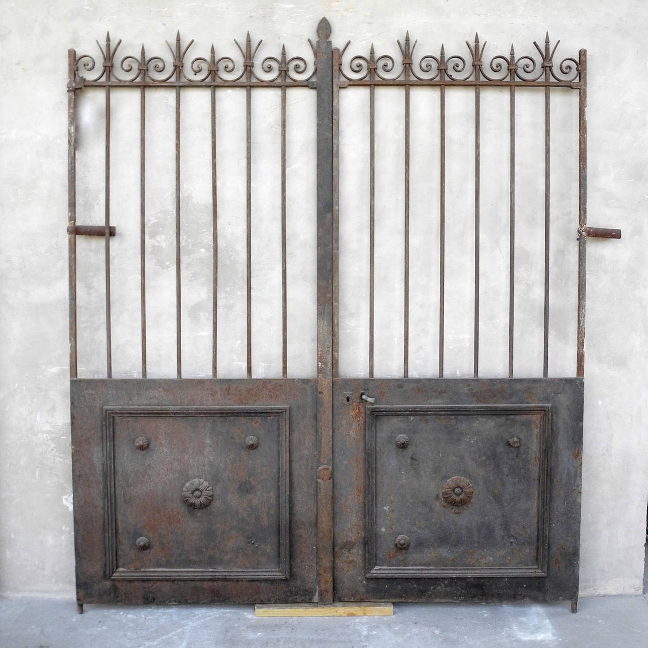 This pair of 19th century antique gates, or portail, originally stood at the front of a Bastide near Apt, France. These gates have retained their beauty and integrity over the last two hundred years and still sport their original swirled designs on