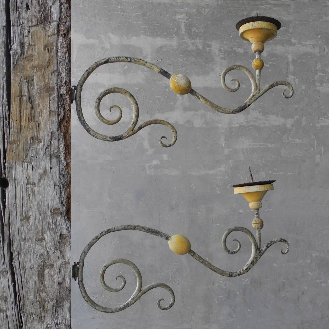 This unique pair of 18th century Italian appliques sports a beautiful grey and green patina combined with bright yellow accents. Hand-crafted and in excellent condition, this pair of sconces would be an eye-catching addition to any home.