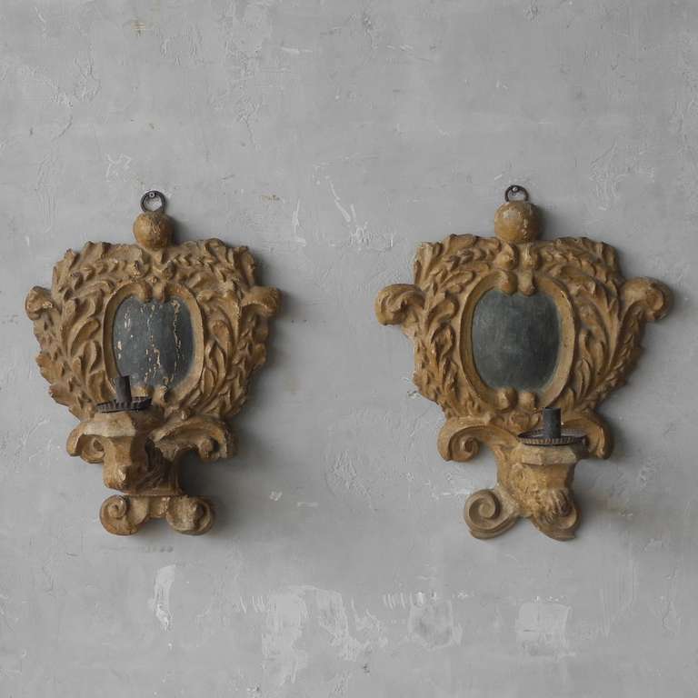 This pair Louis XIV appliques was created in the Piedmont Region of Italy, circa 1700. They warm-colored wood is carved with a beautiful pattern and two carved arms were made to hold candles.