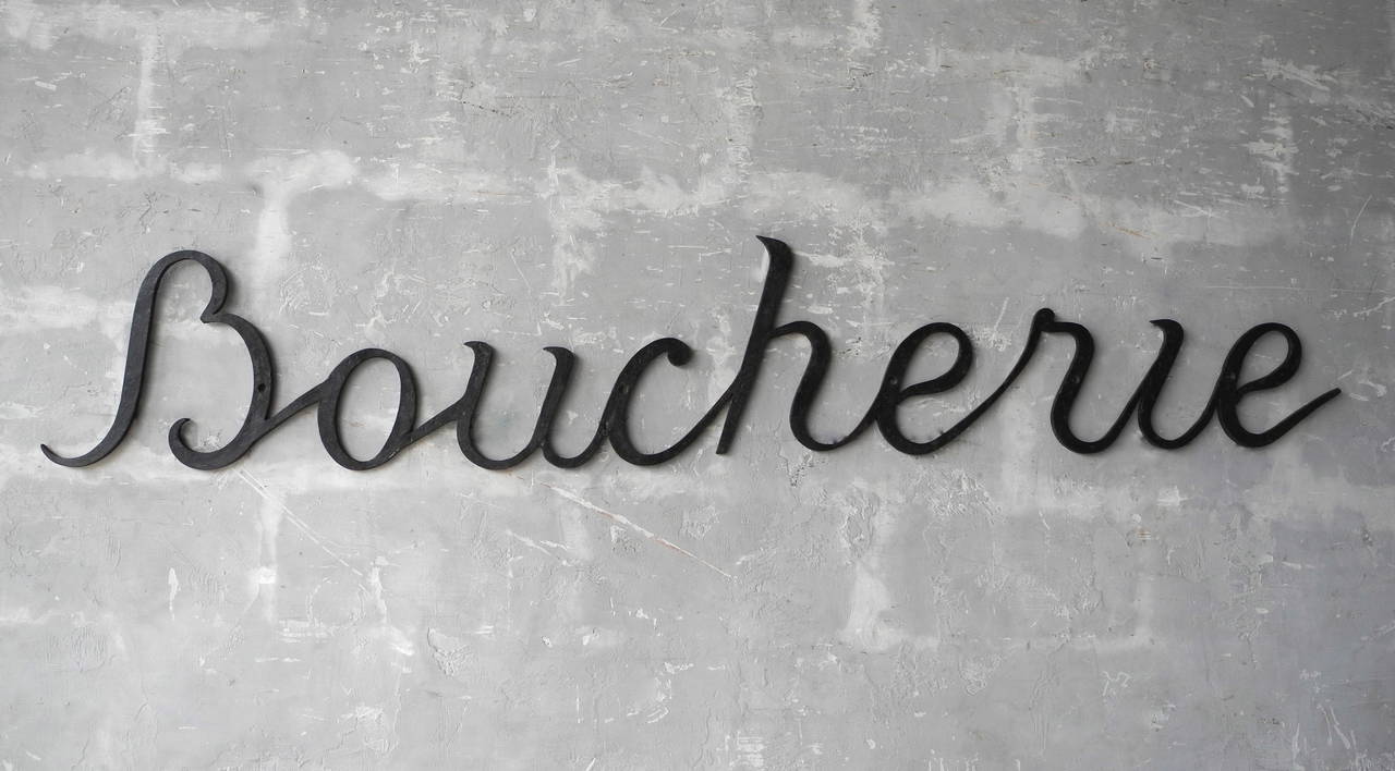 This metal antique boucherie sign originally hung outside of a French butcher's shop. Boucheries, which translates to Butchery in English, would have sold meat and other products to locals. 

This sign would add whimsy and charm to a sophisticated