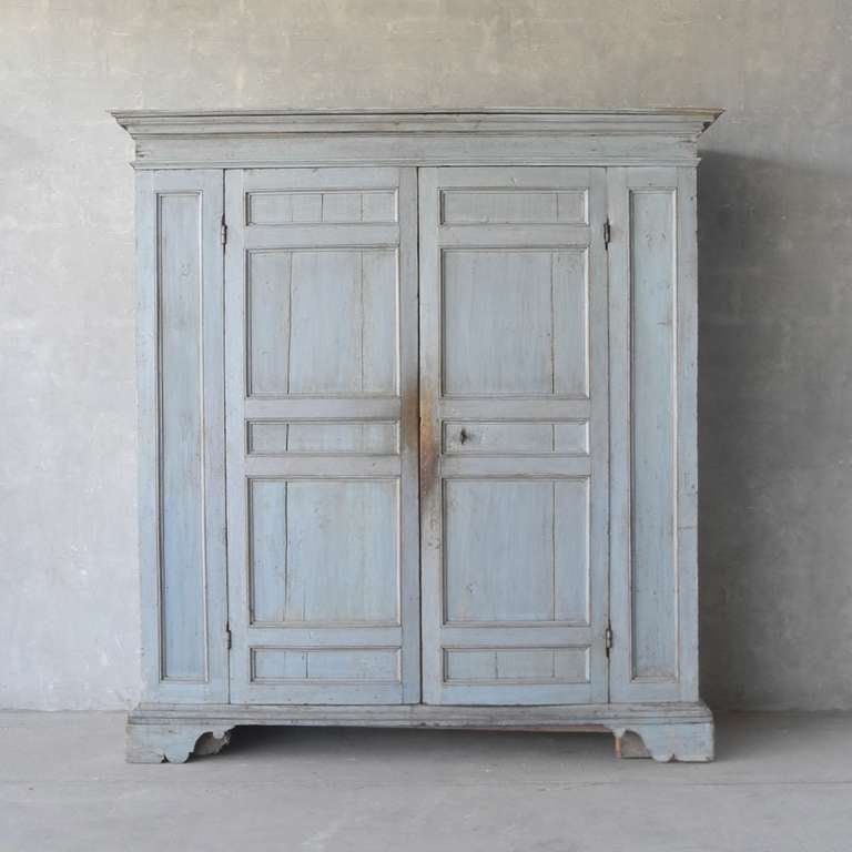 This stunning 17th century armoire was originally used in a convent in the Tuscan village of Lucignano. The interior of the armoire features shelving and locking mechanisms. The pale blue patina of this piece keeps it light despite its monumental