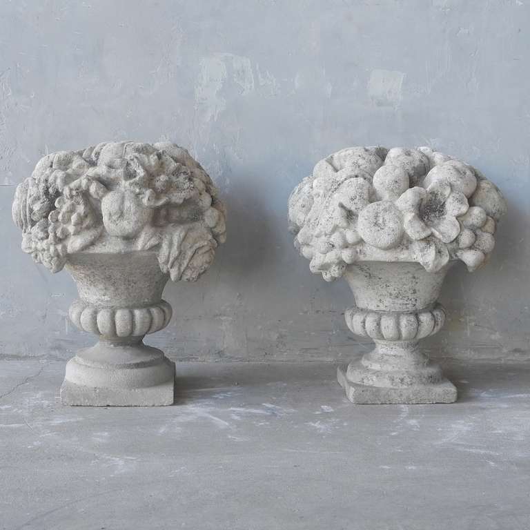 This pair of 19th century carved stone corbeilles feature two vase-like shapes filled with carved fruit and flowers. This elegant pair would compliment any garden space or nicely flank an entrance door. Can be used as statues, columns toppers, of