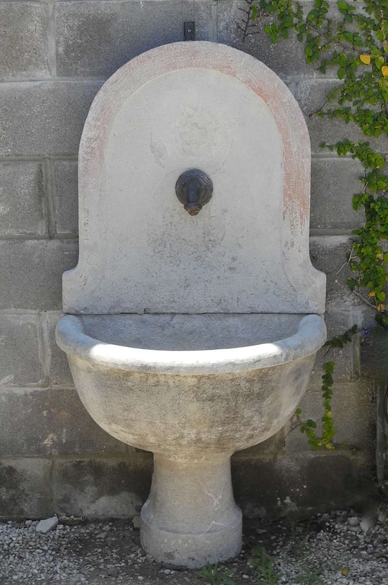 This small 18th century stone fountain with antique spout was reclaimed from the courtyard of an Umbrian country house. Petite in size and simple in nature, this fountain is the perfect addition to any small garden space.