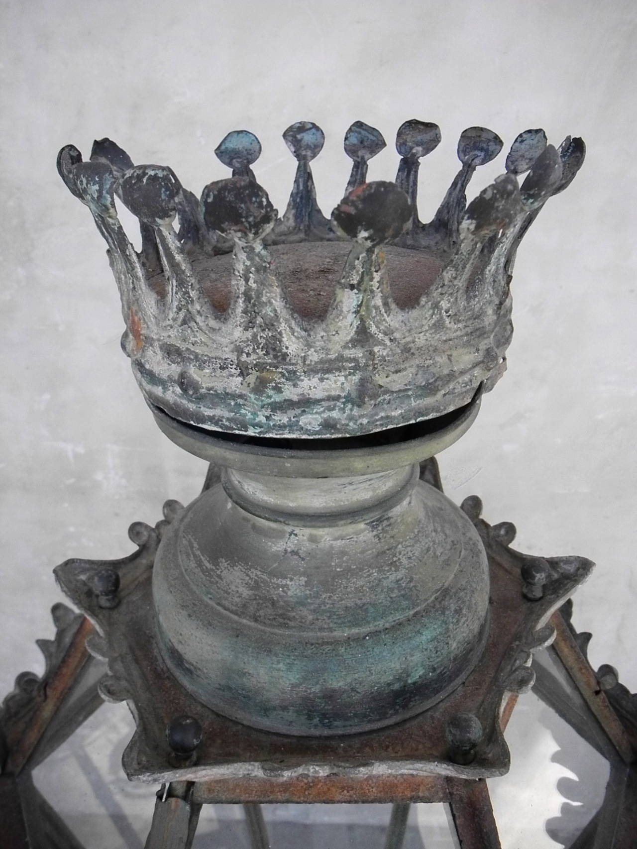 This 19th century Spanish lantern, topped with a large hand-hammered crown, originally hung in a casa important in Madrid, Spain. At over three feet in height, the monumental size of this lantern makes it an intriguing find. This unique item would