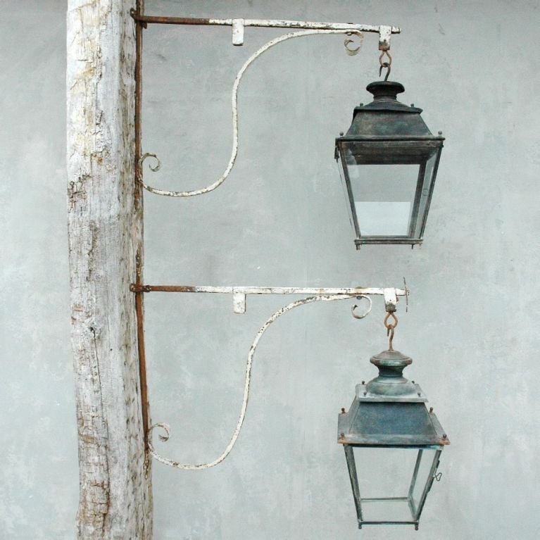 Pair 17th c. Tuscan potences with 19th c. lanterns.  One door on each lantern opens to access interior.  Iron potence attaches to wall.  White paint detail on potence.  Priced and sold as a pair.