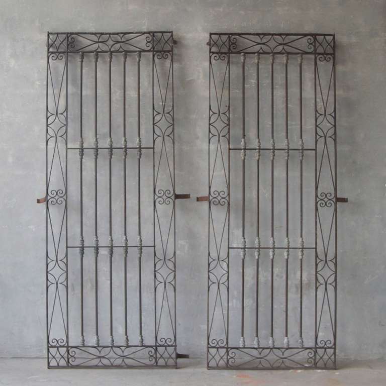 This pair of 18th century forged iron window grilles originally covered the windows of a maison de ville in Uzes, France. These ornate and unique pieces would effortlessly add charm and sophistication to your residence.