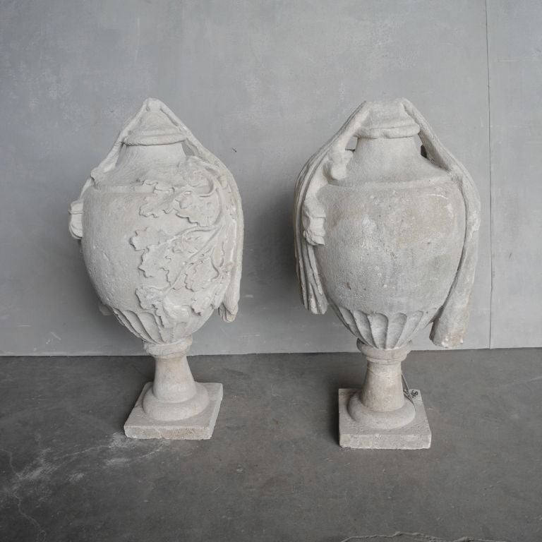 This pair of 18th century stone finials were reclaimed from a garden in France. Priced and sold as pair, this lovely couple would look great on a terrace or even flanking an entryway.

The elegant shape and added details of leaves make this pair