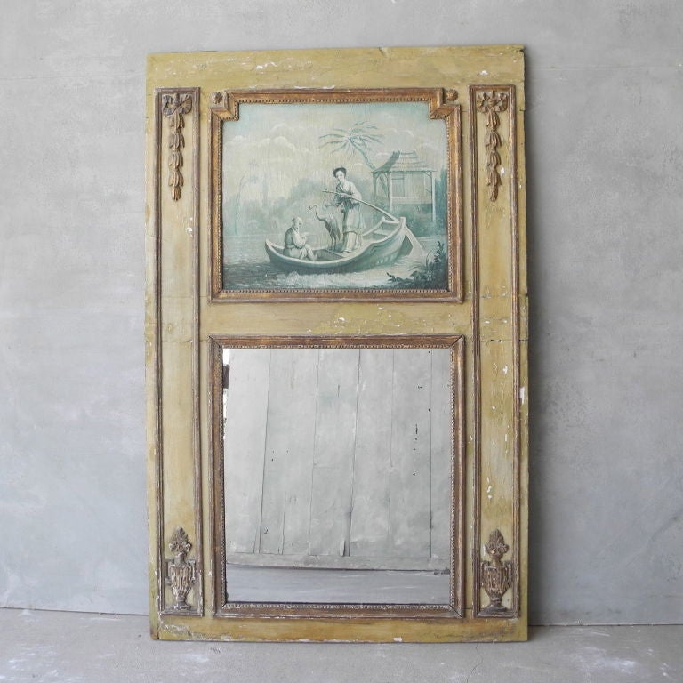 This antique 18th century trumeau mirror has its original paint and art. It includes  beautiful carvings that are gold in color. This piece is perfect for a large wall of above a mantel. 