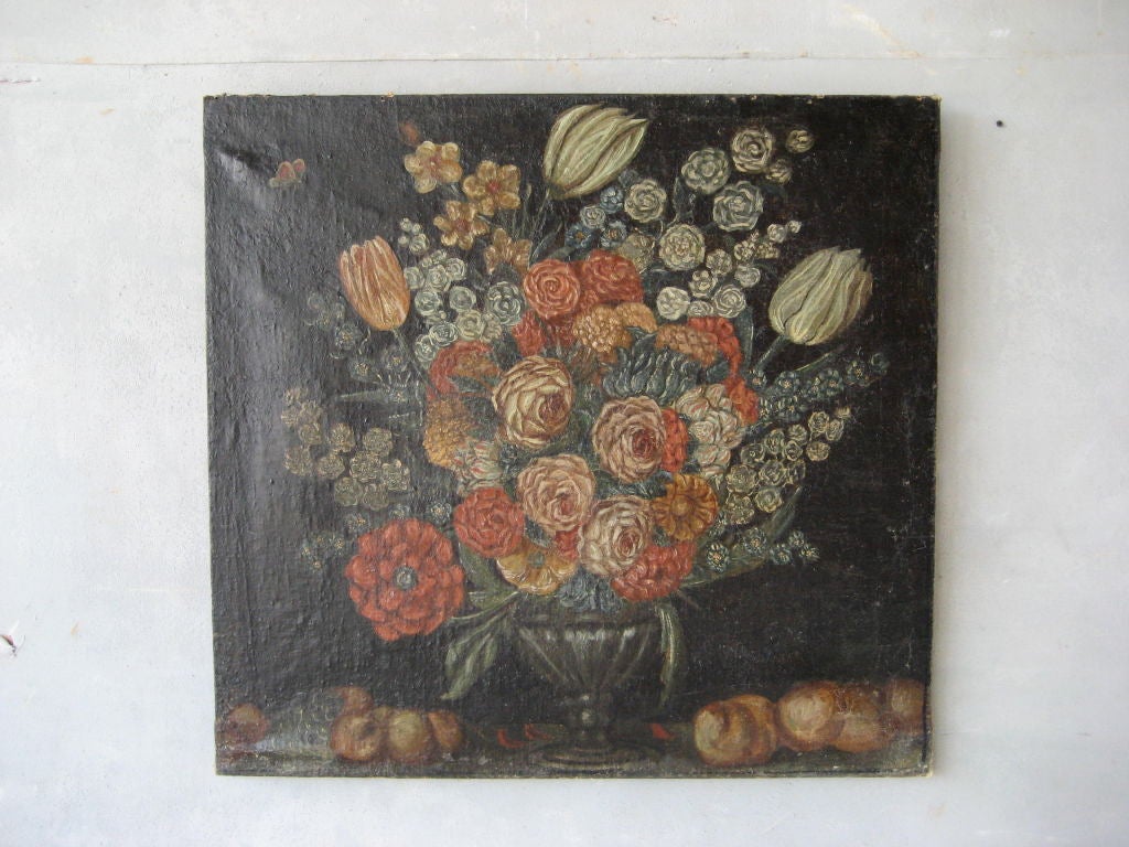 This 17th-century French oil painting of a flower arrangement features nailhead trim and a wood back. It has been slightly touched up, so it is in great condition. 