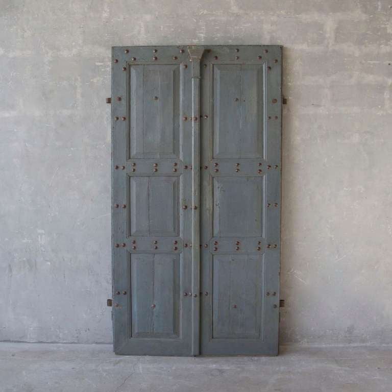 This is a lovely pair of large 18th century entrance doors from a village house in the Pyrenees. They include their original blue patina as well as original antique hardware - nails and hinges. They are perfect for any entryway and can have a