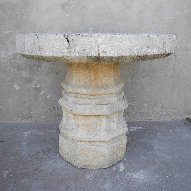 This 16th century stone column table originated in the Burgundy Region of France. This piece bears a curious carving on one of it's sides. The symbol might be a nod to the legendary story of King Arthur - Arthur was deemed the heir to the British