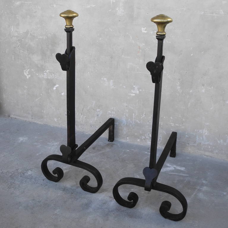 This pair of 16th century Spanish Andirons are a special find! These iron pieces feature a special gold-colored toppers and heart shaped movable pieces. 

In excellent condition, these andirons would be the perfect addition to an antique fireplace.